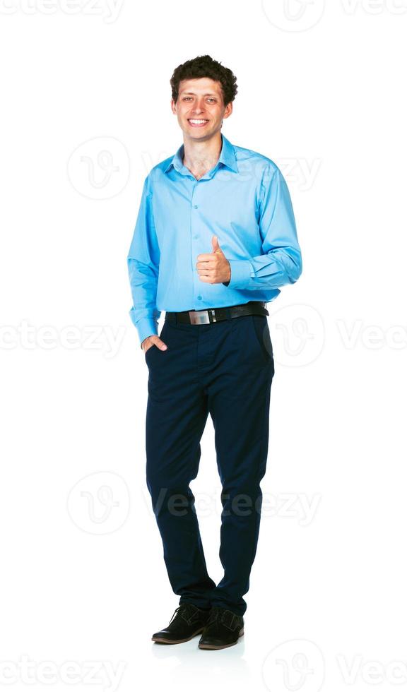 Happy young businessman standing with thumb up on white photo