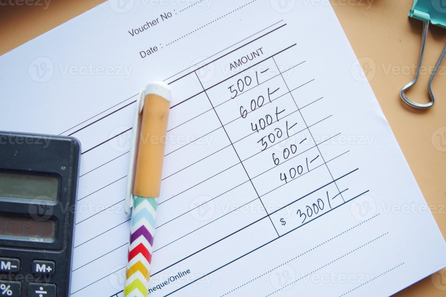 A man writes payment due in a paper form photo