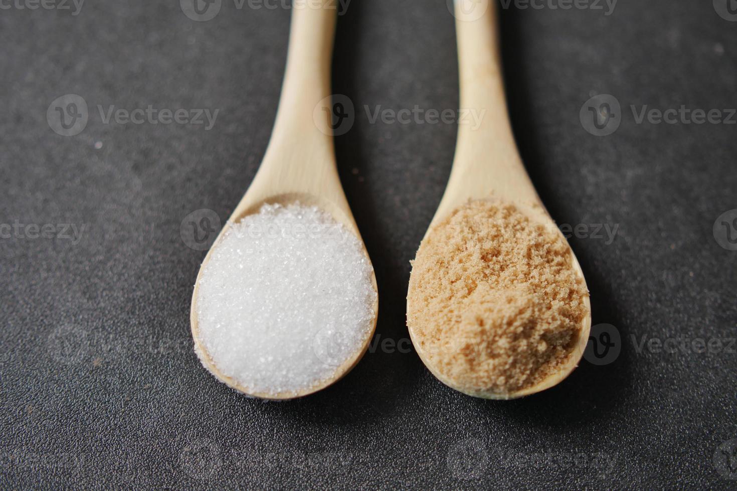 comparing white and brown sugar on spoon photo