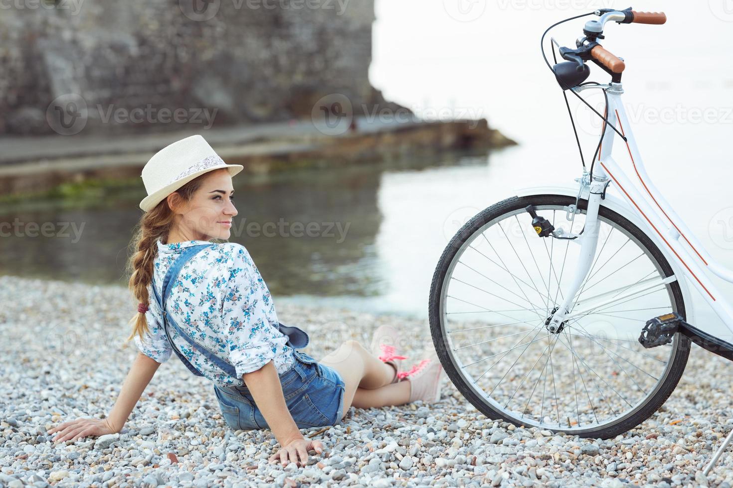 Happy woman with bicycle on the beach photo
