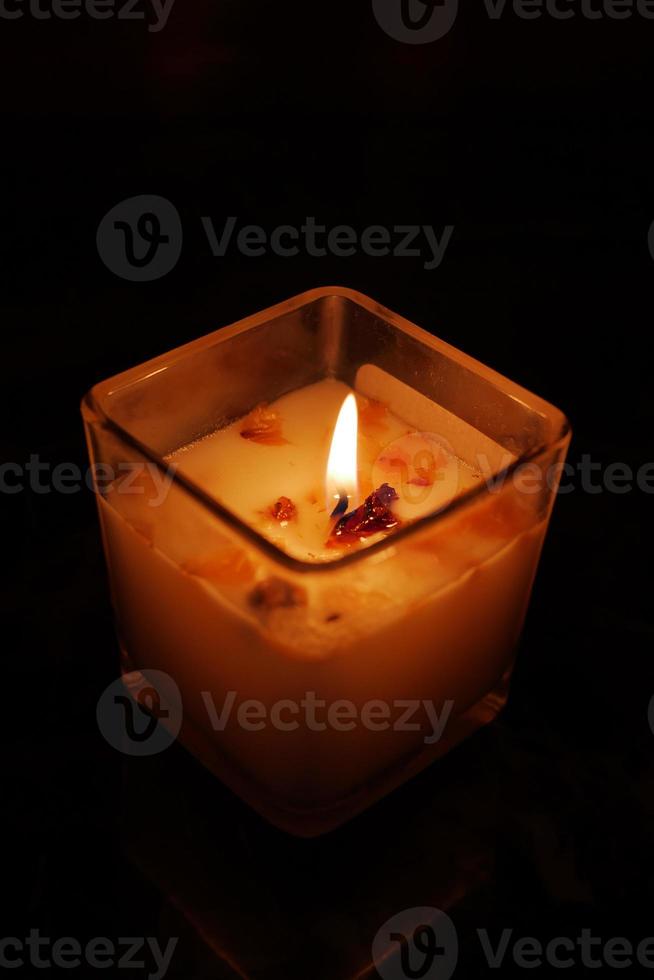 color candles slowly burning down in dark photo