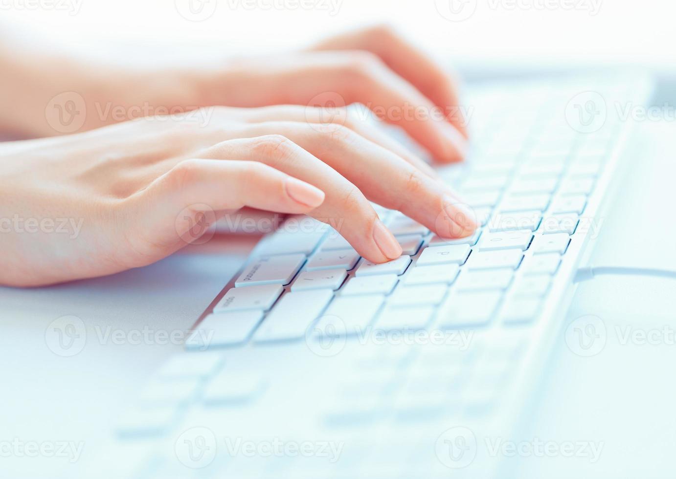 Female hands or woman office worker typing on the keyboard photo