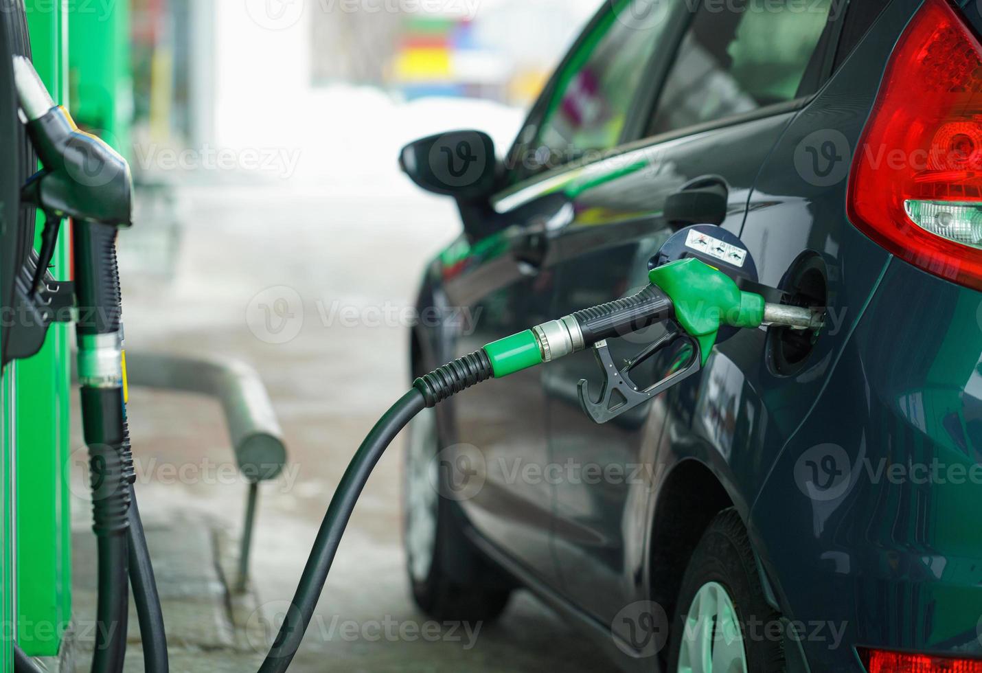 Car refueling on a petrol station in winter close up photo