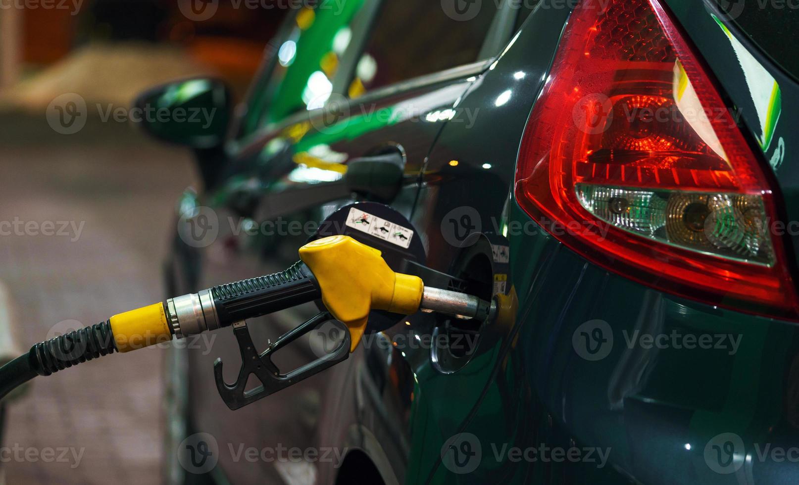 Car refueling on a petrol station in winter at night photo