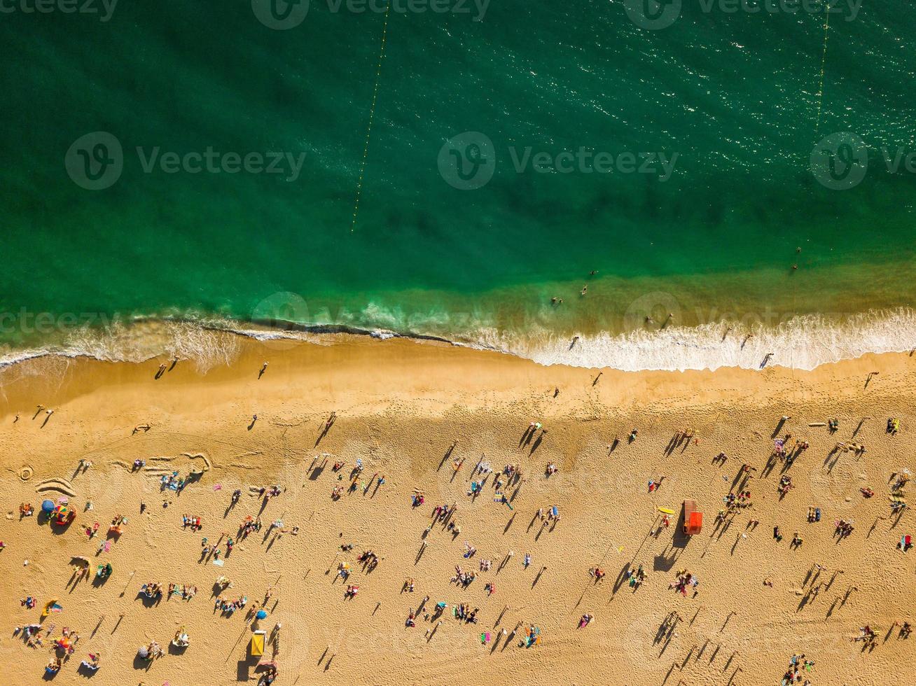 View from above to a busy beach. Coast of the Atlantic Ocean photo