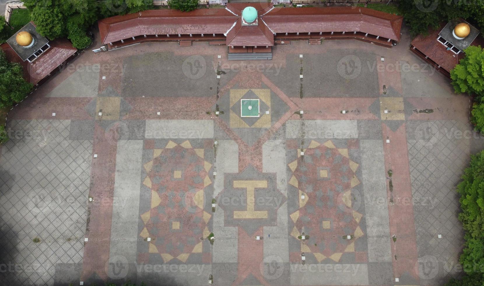 A view of the beautiful field in the middle of the city square by drone, this field is for ceremonies, sports, music concerts, special markets or other events photo