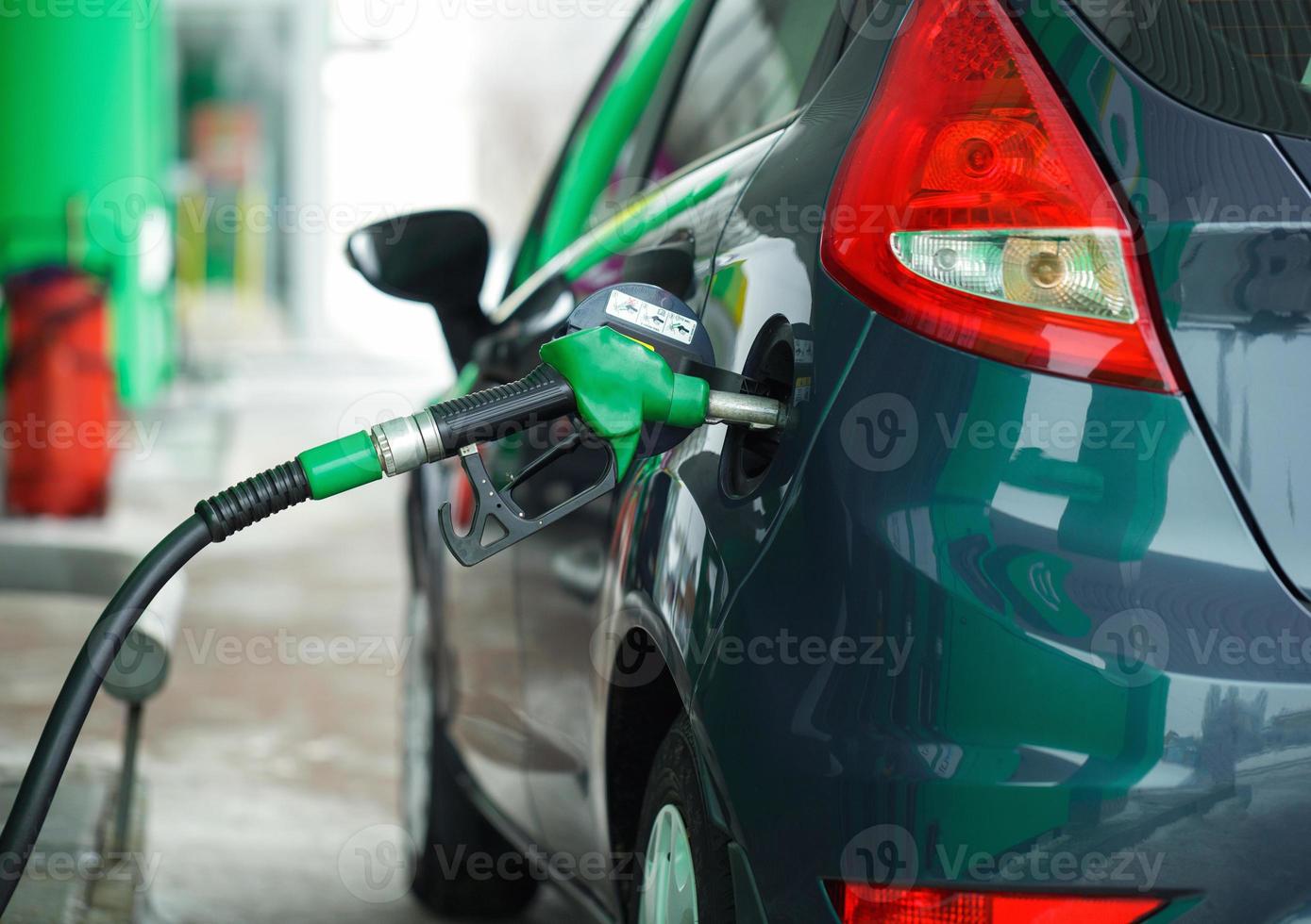 Car refueling on a petrol station in winter close up photo