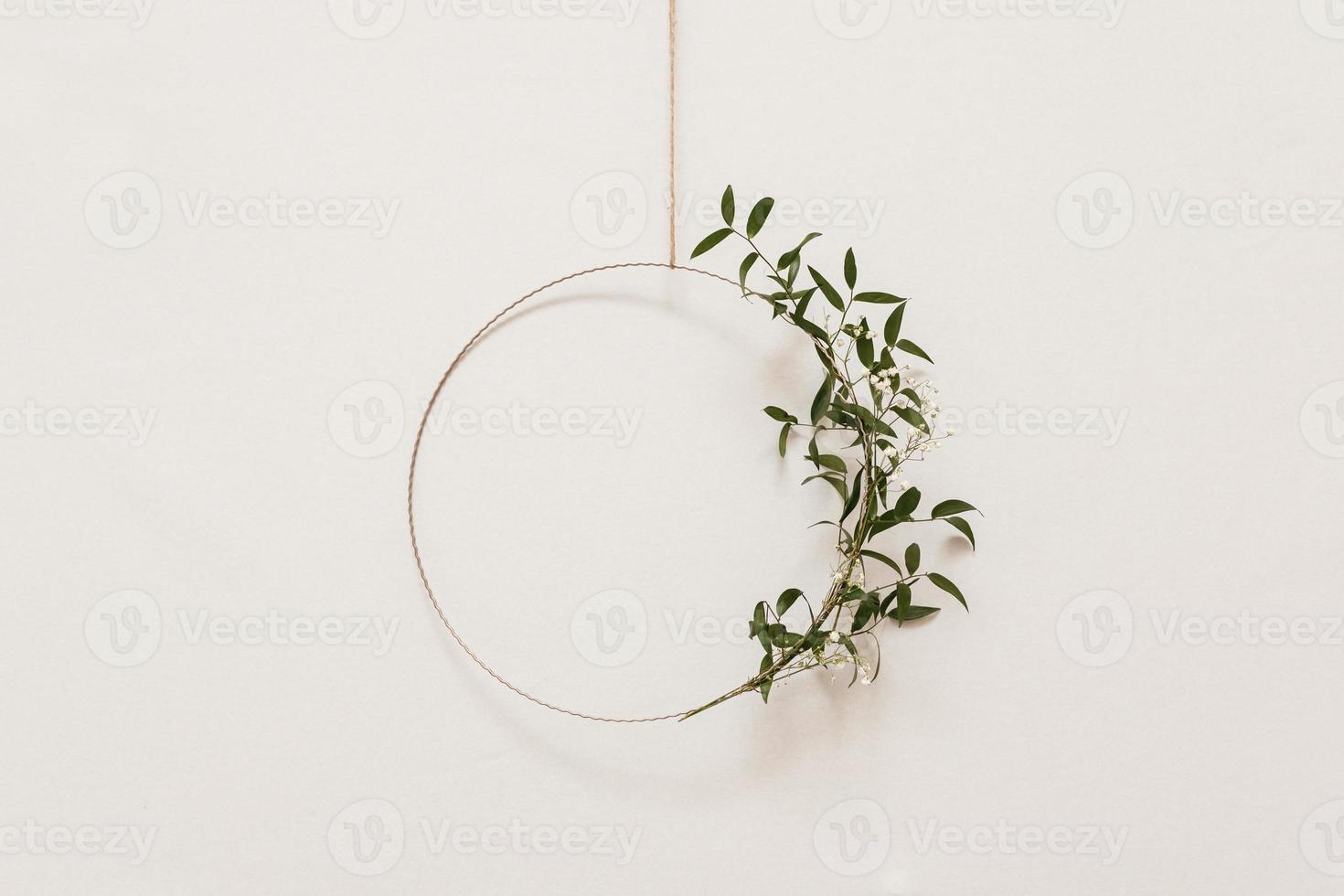 floral and metal construction on white wall background photo