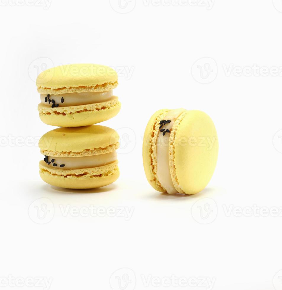 three cake of macaron or macaroon yellow lemon color. Delicious macaroon isolated on white background. French sweet cookie. photo