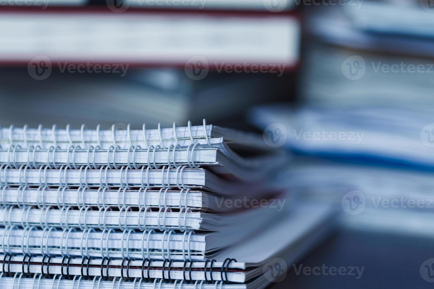 Accounting and taxes. Pile of magazine, notebook and books closeup photo