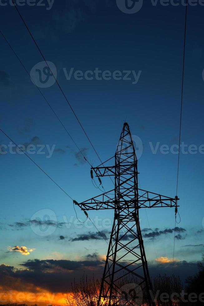 Power lines against the sky at sunset photo