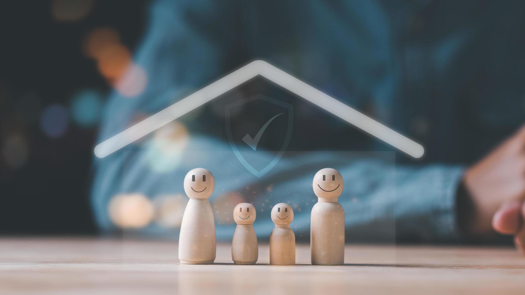 Wooden dolls and icons represent the protection and protection of family safety ,property and family risk reduction ,Caring and caring for loved ones ,life and property protection planning photo