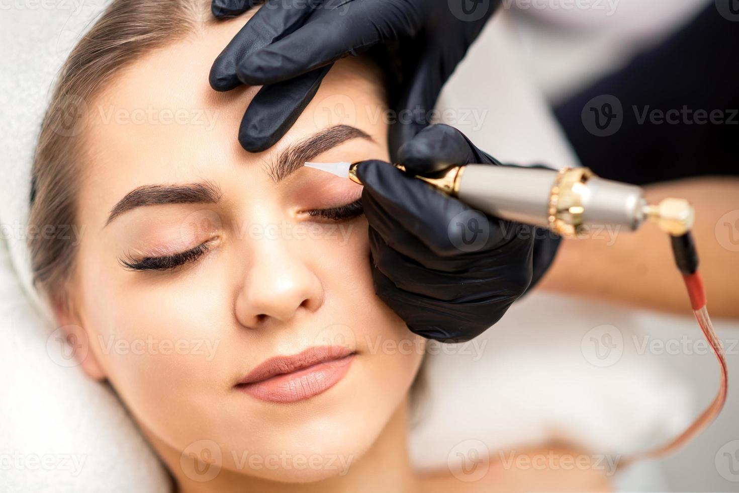 Permanent makeup on female eyebrows photo