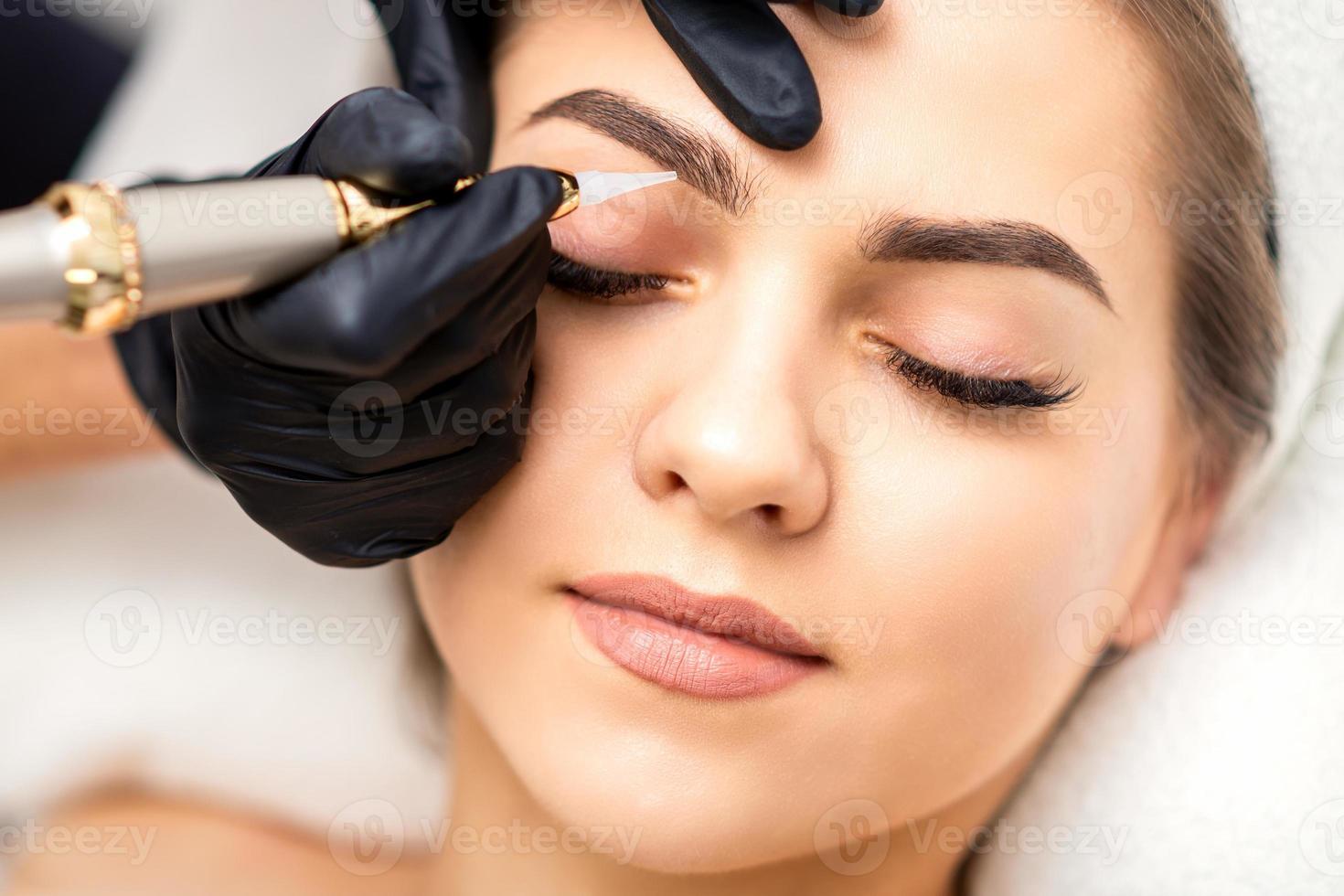 Permanent makeup on female eyebrows photo
