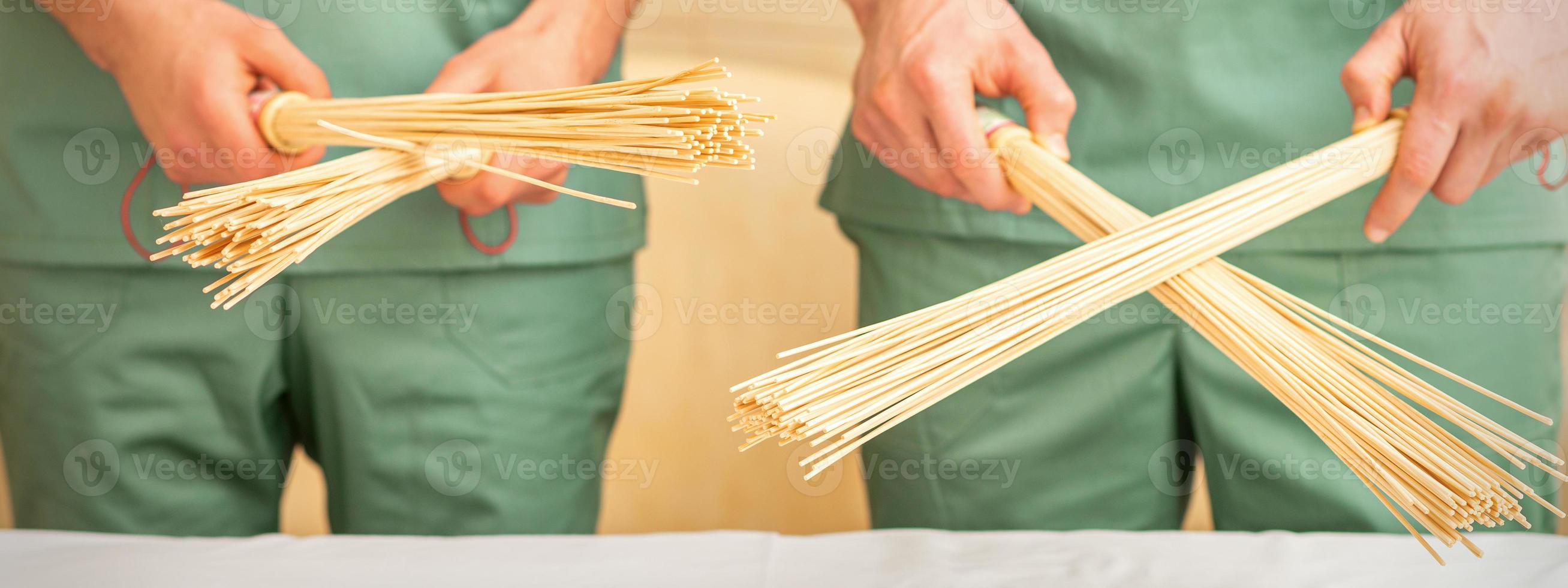 Bamboo massage brooms in hands photo