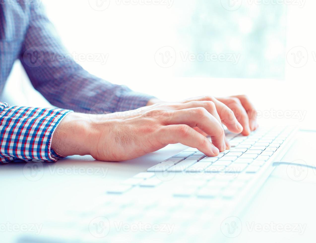 Male hands or men office worker typing on the keyboard photo
