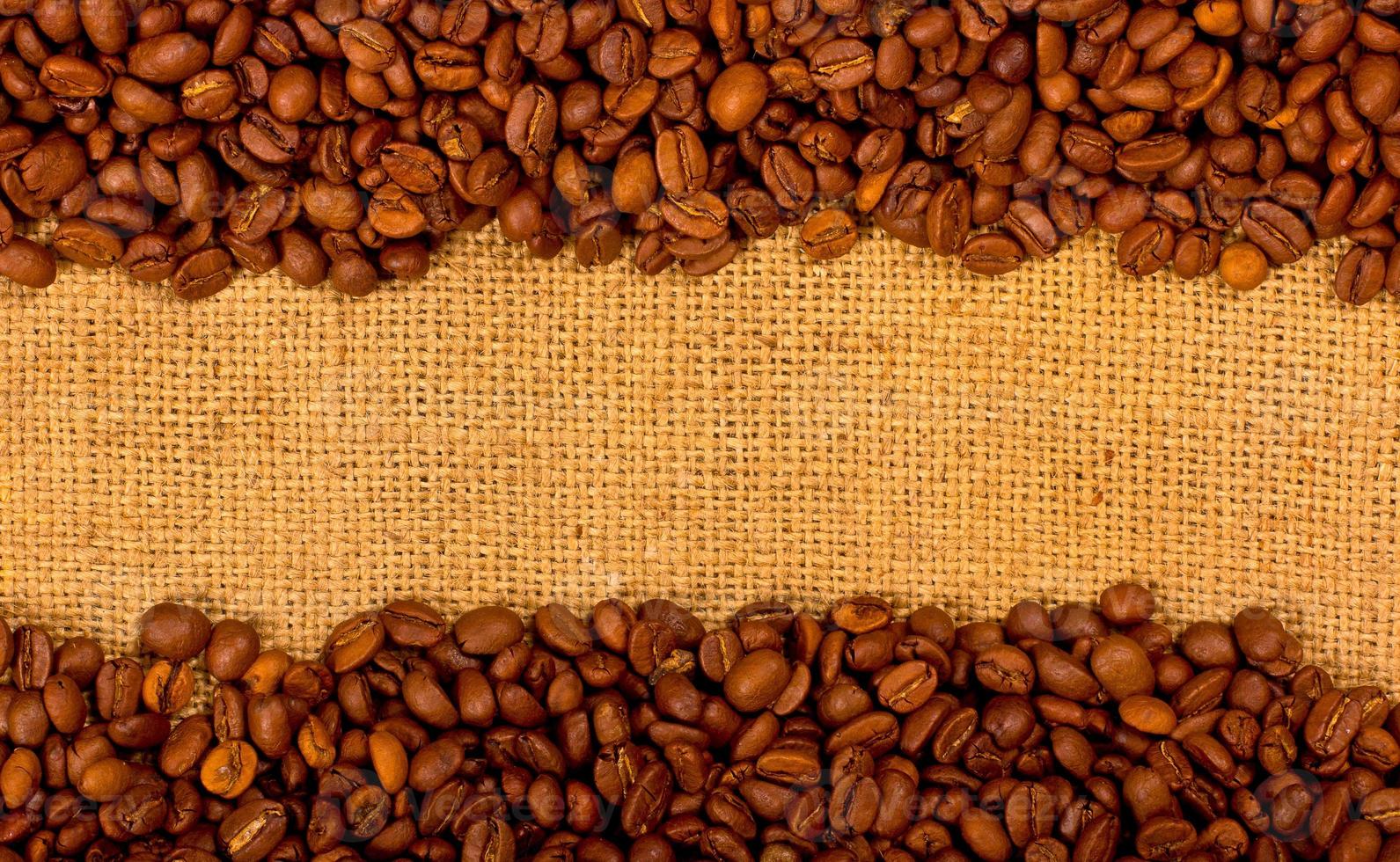 Coffee grains on the burlap background photo