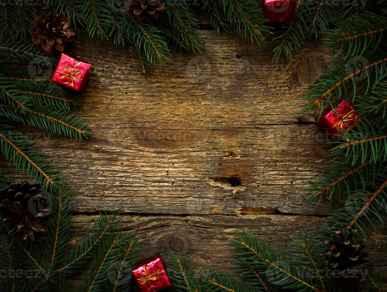Christmas tree branches with christmas decorations on wooden texture photo