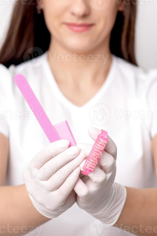 Manicure tools in hands of manicurist photo