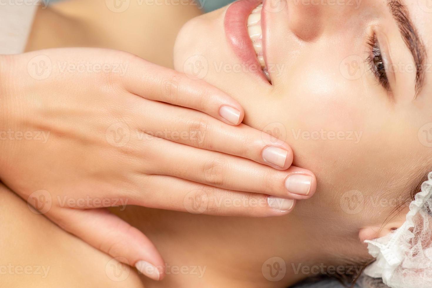 Woman lying and touching face skin photo