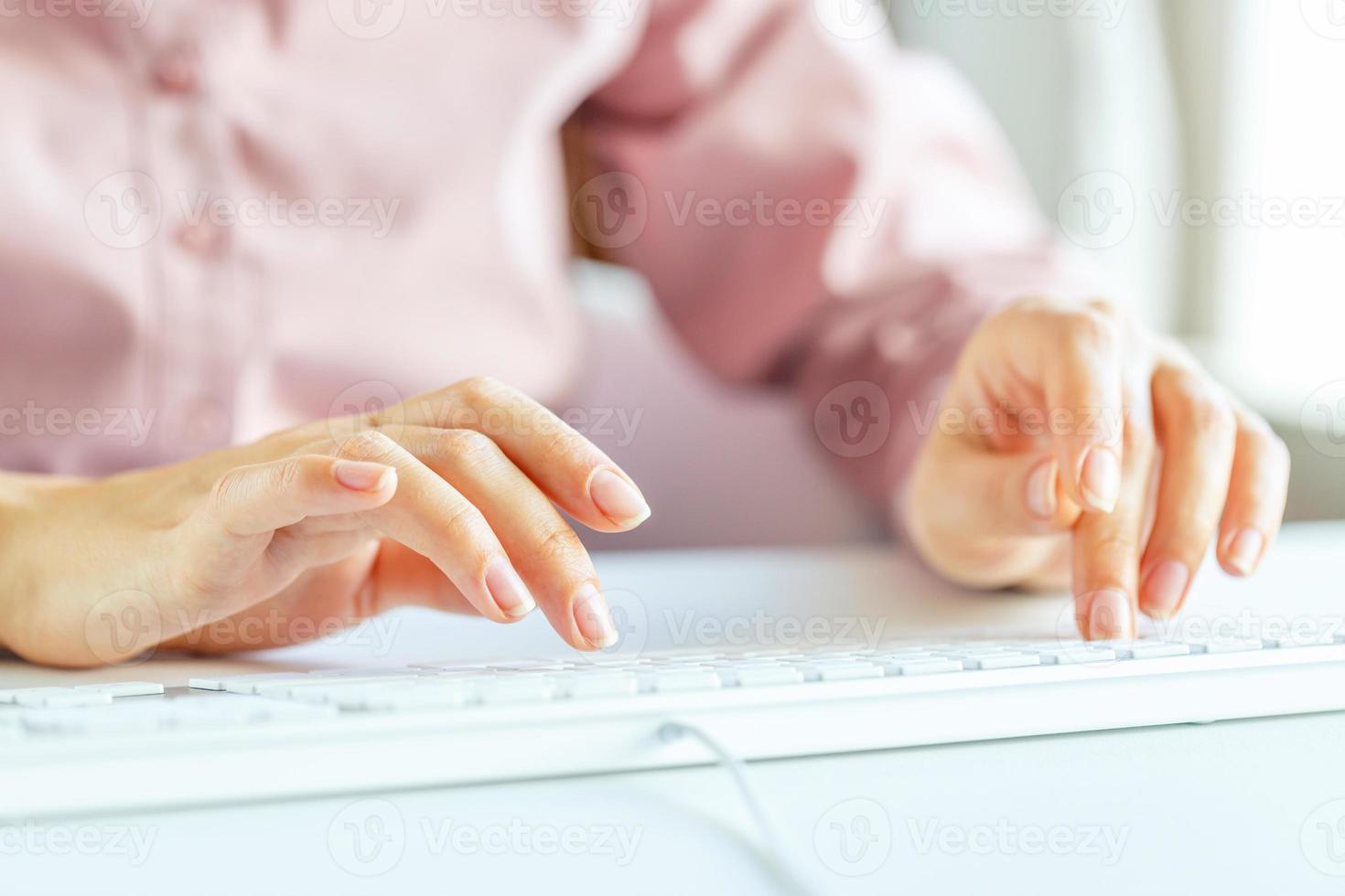 Woman office worker typing on the keyboard photo