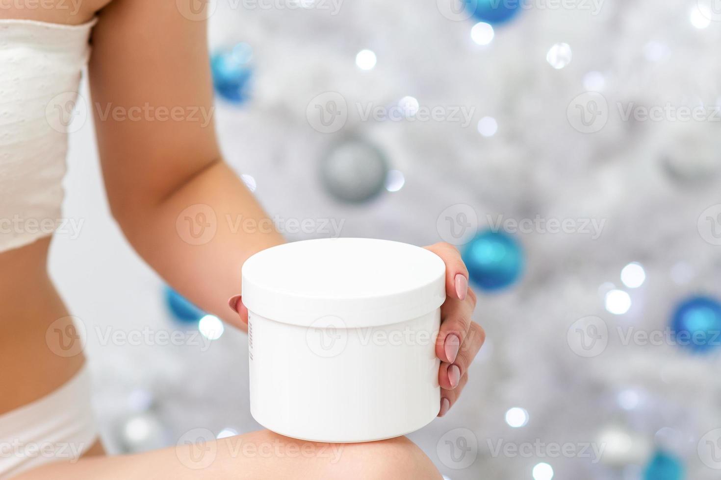 White plastic jar in hand of woman photo