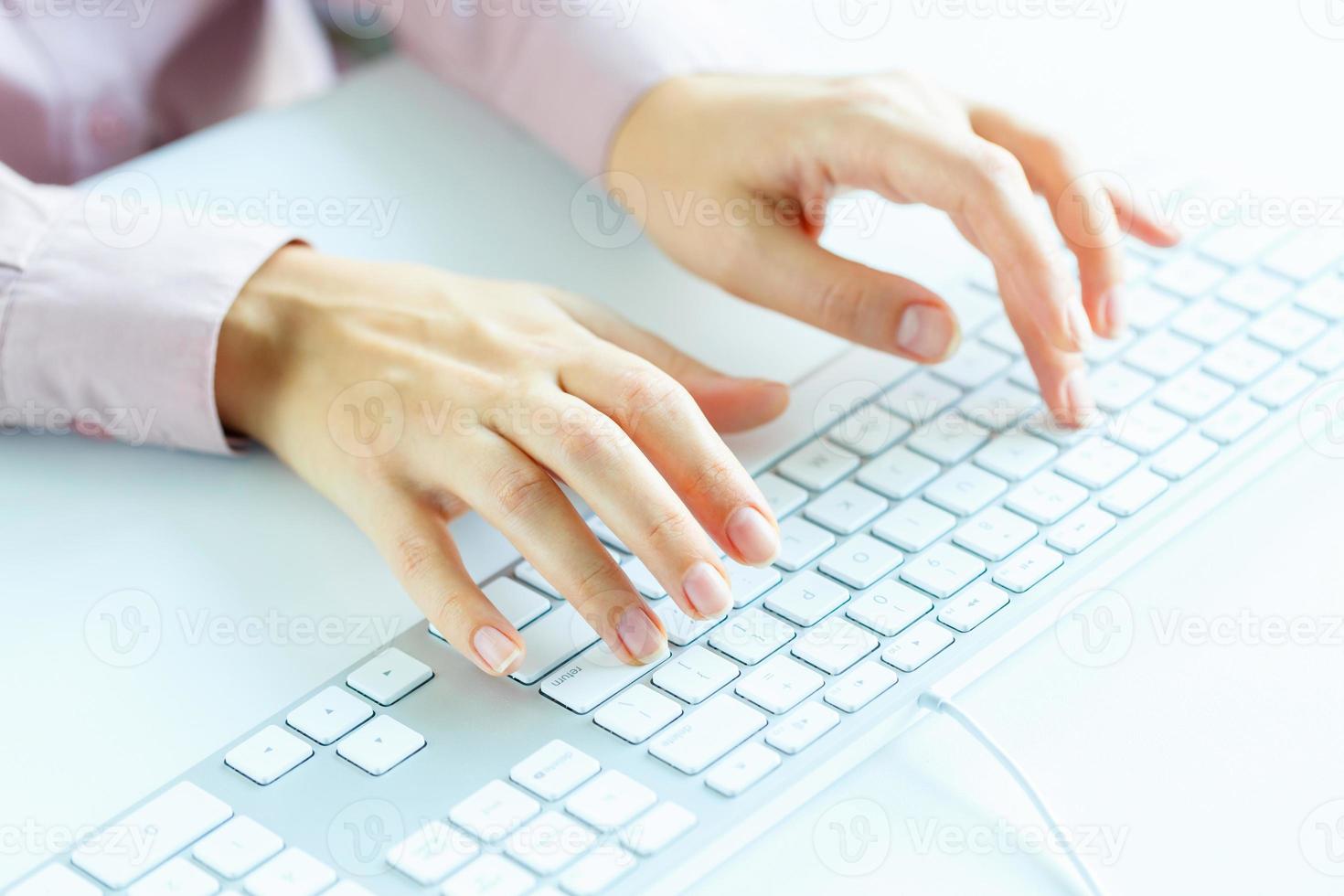 Woman office worker typing on the keyboard photo