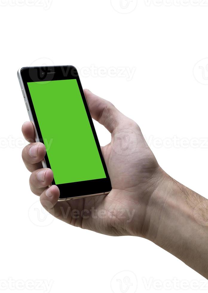 Male hand holding black cellphone with green screen at isolated white background. photo