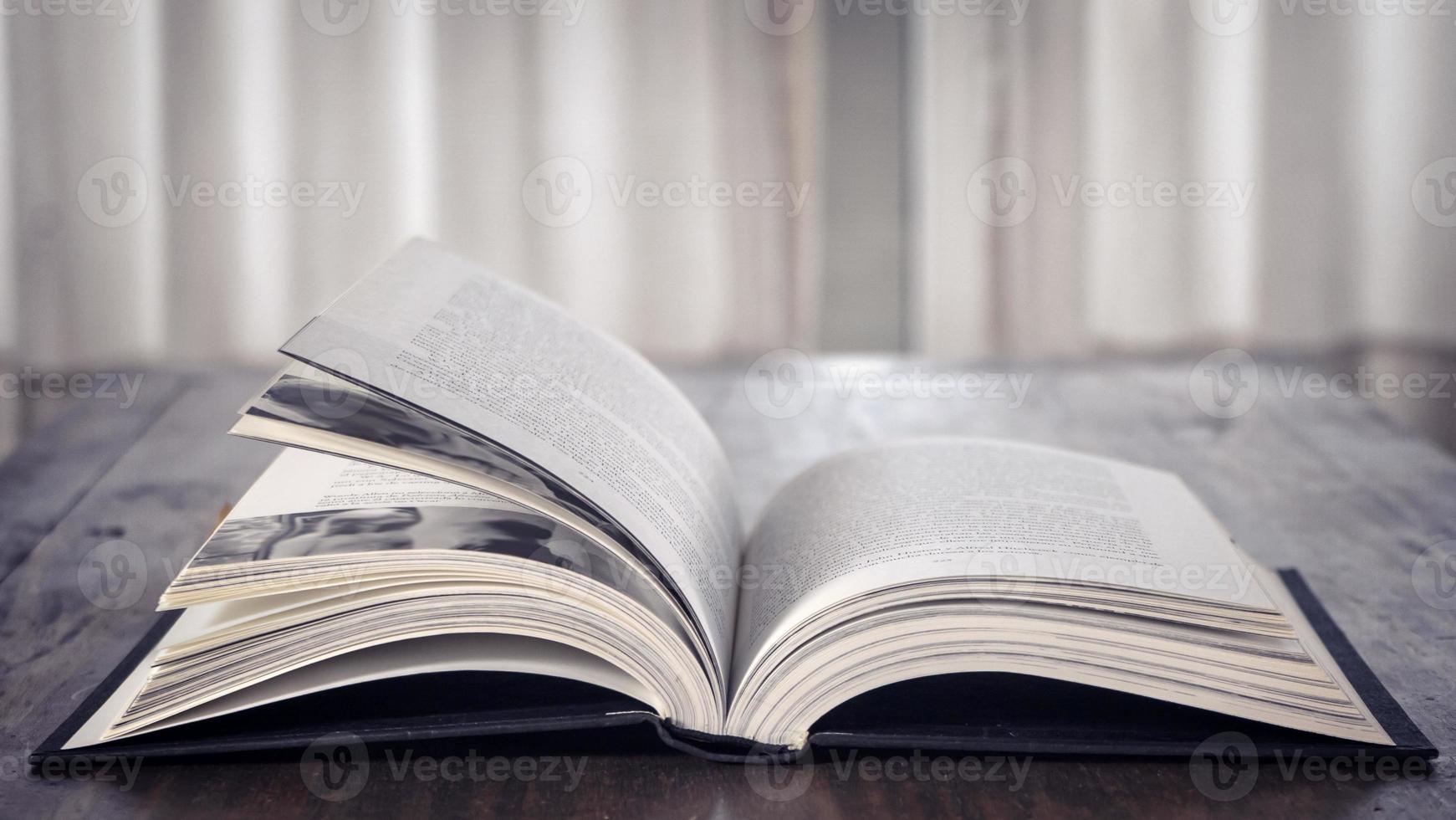 Open book over wooden table. Library. Literature. Read. Study photo