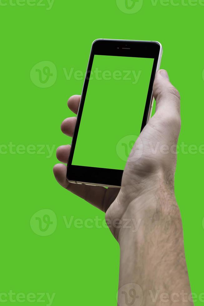 Male hand holding black cellphone with green croma screen at isolated Green background. photo