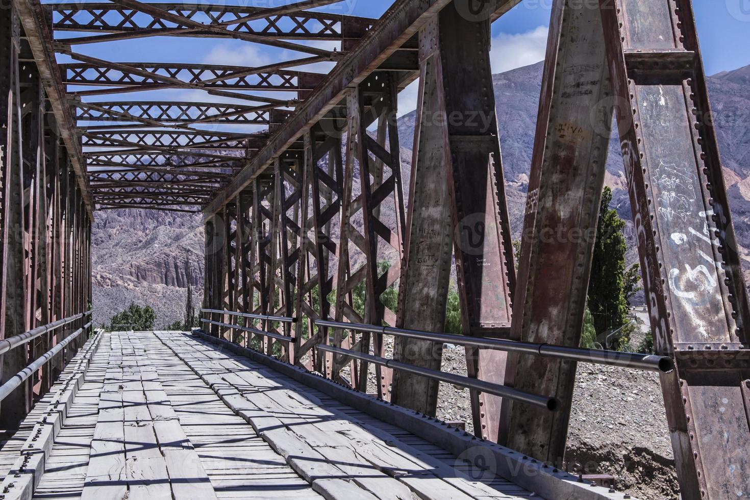 Perspective metal bridge into the mountains photo