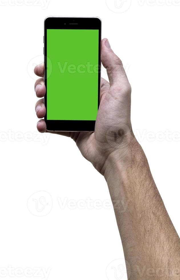 Male hand holding black cellphone with green screen at isolated white background. photo