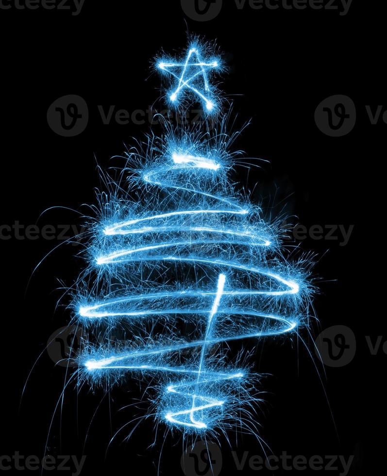 Christmas tree made by sparkler on a black photo