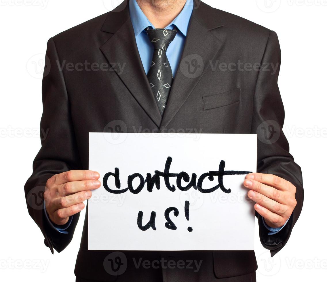 Young businessman points on a card Contact Us on a white photo