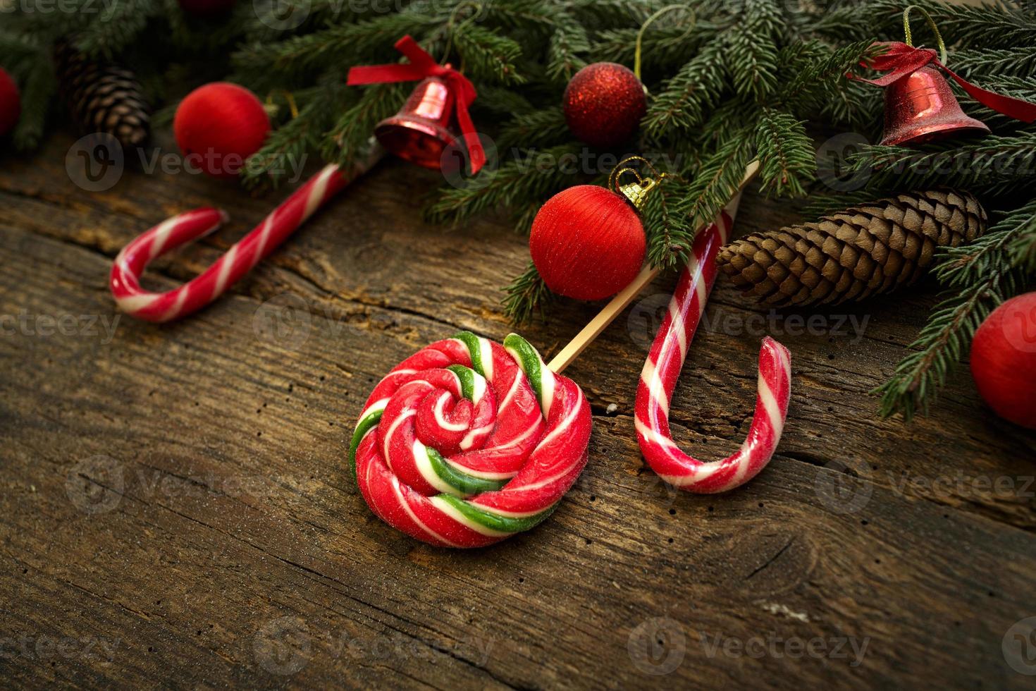 Christmas border with fir tree branches, cones, christmas decorations and candy canes photo