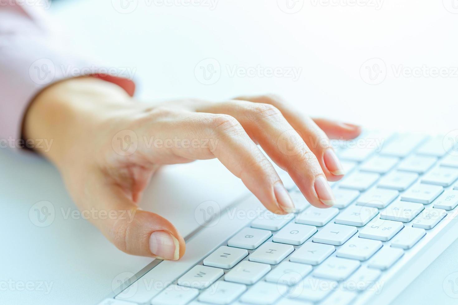 Woman office worker typing on the keyboard photo