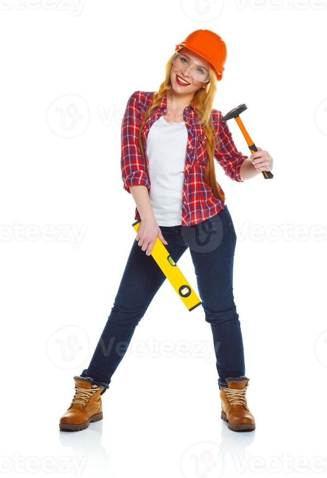 Young woman in helmet with the work tools on a white photo