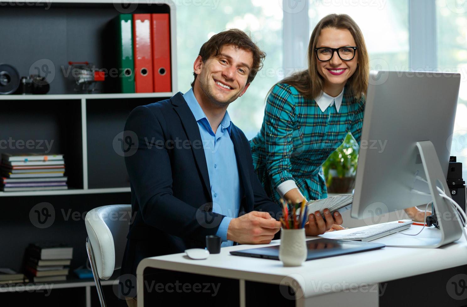 Beautiful young woman and man working from home photo