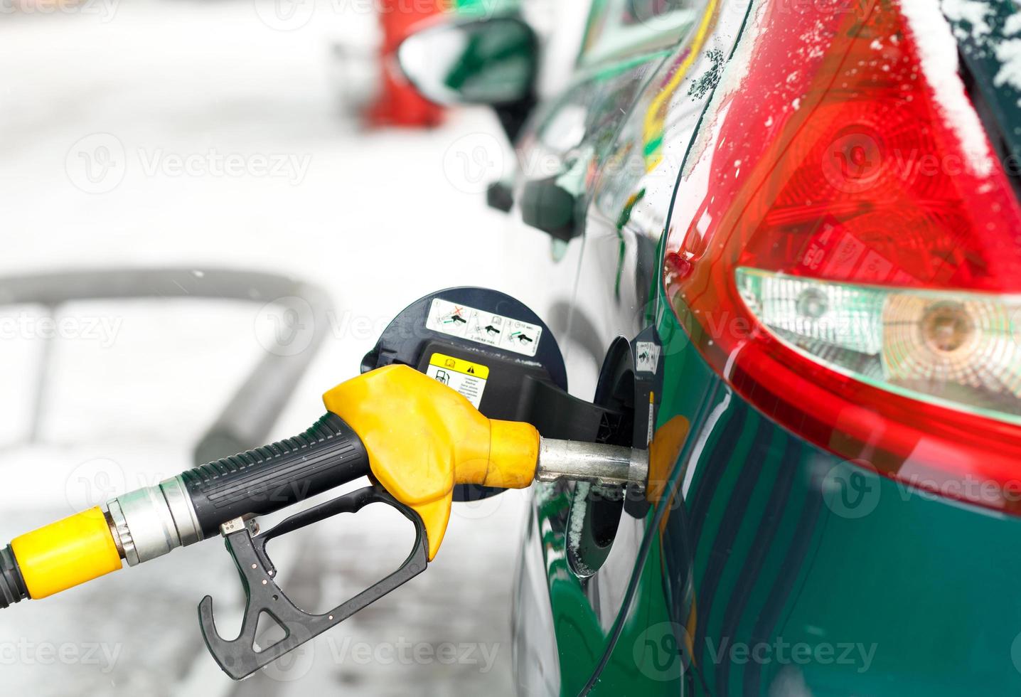 Car refueling on a petrol station in winter photo