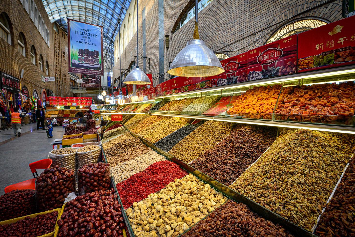 Variety of brightly colored and nutritious locally produced dried fruits and nuts at the New Grand Bazaar in China photo