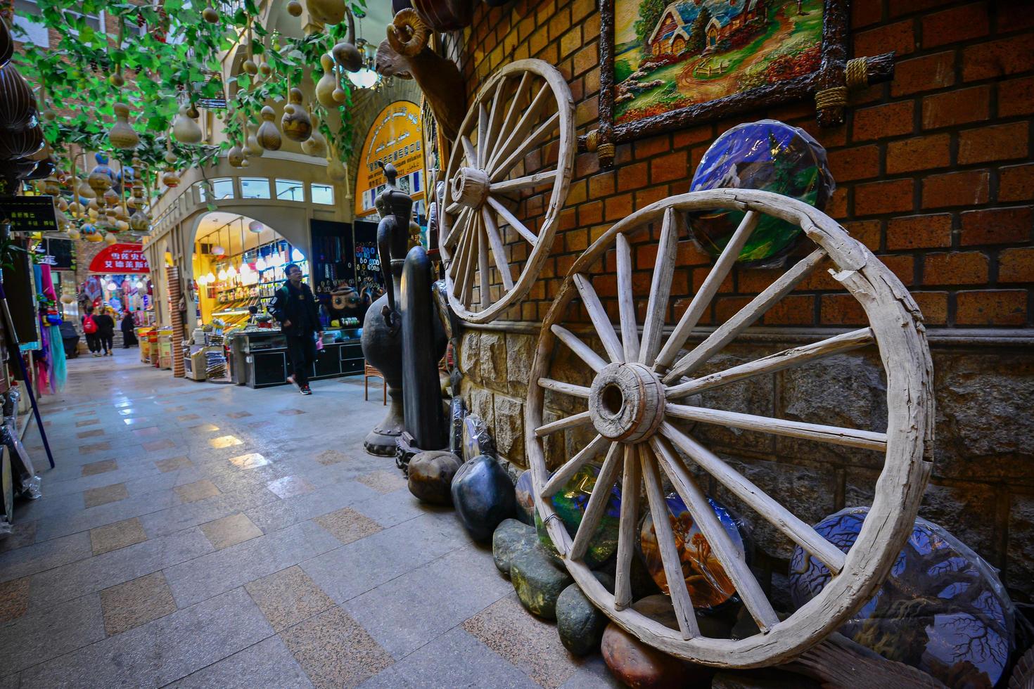 In the Grand Bazaar in Xinjiang, China, the wooden wheels of the early horse carriages are displayed photo