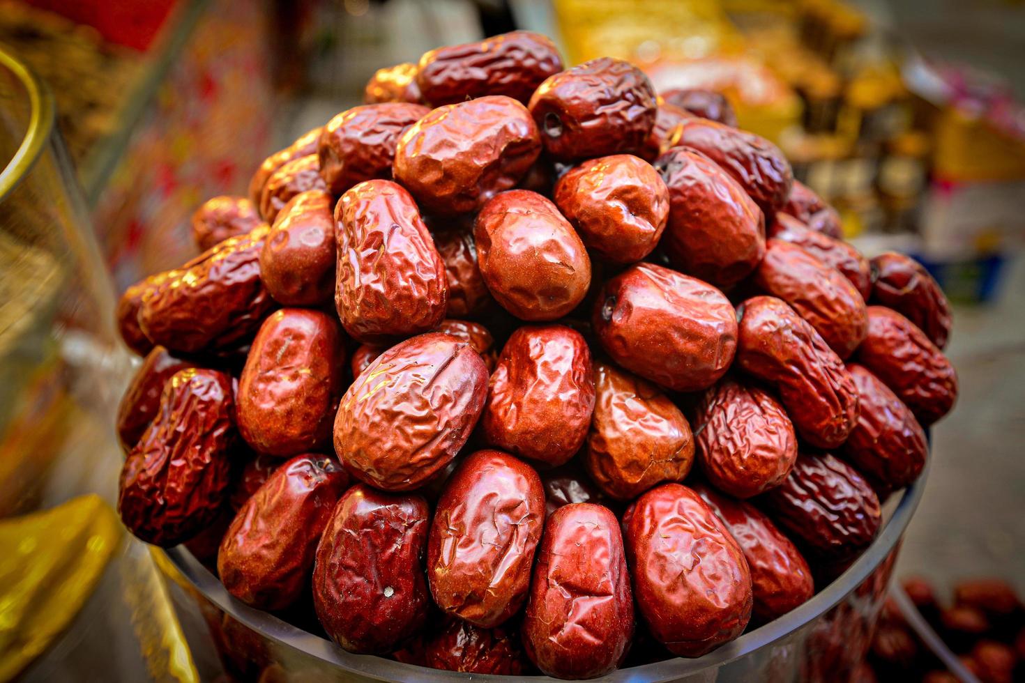 In the Xinjiang Grand Bazaar, a cup full of huge red dates and dried fruits photo