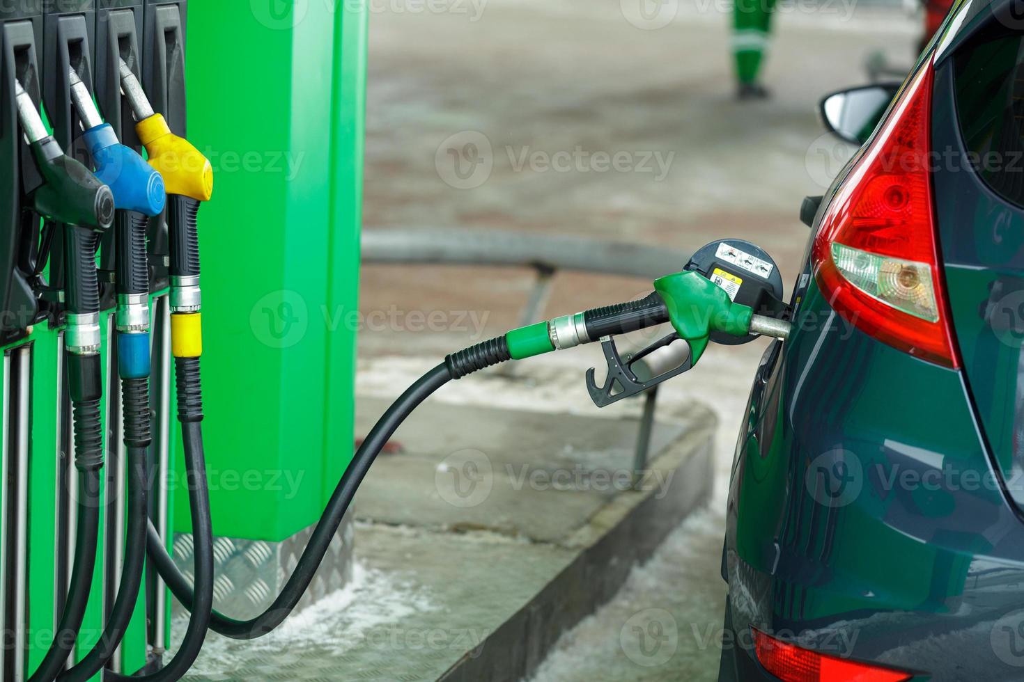 Car refueling on a petrol station in winter close up photo