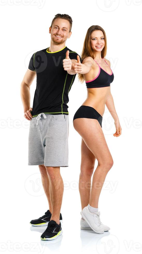 Athletic man and woman after fitness exercise with thumbs up on the white photo