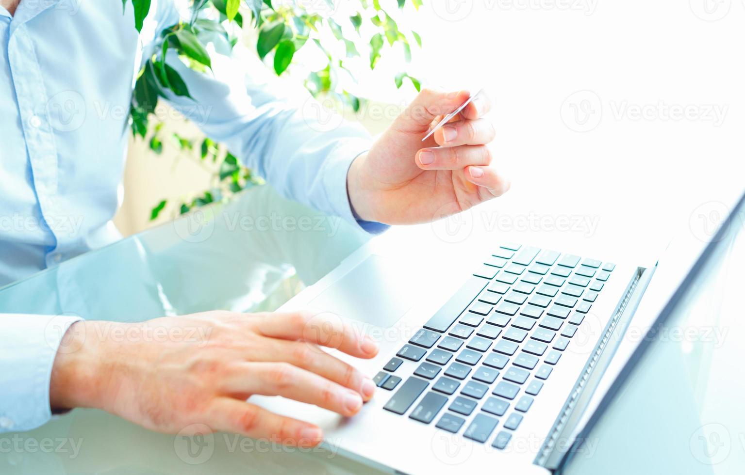 Hands using computer and credit card. Online shopping photo