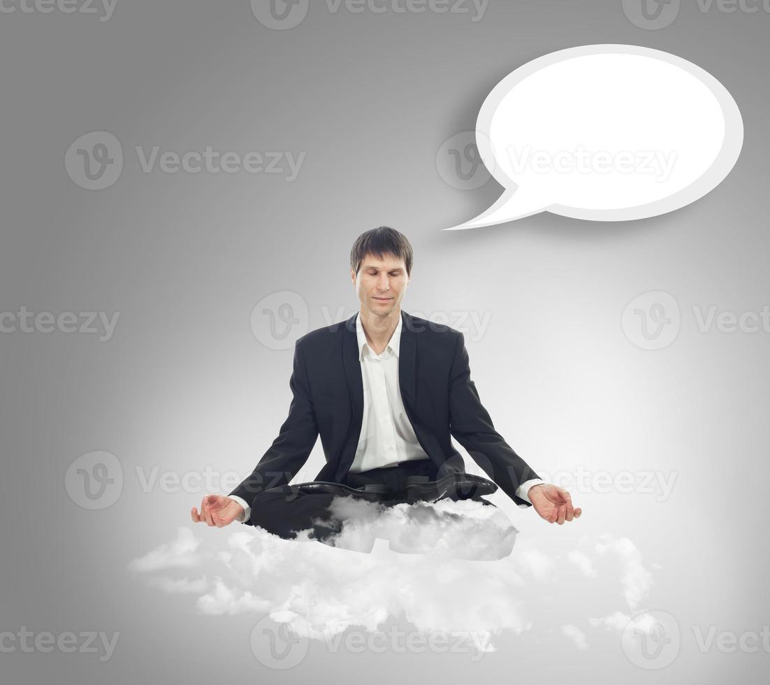 Businessman in lotus position on a cloud photo
