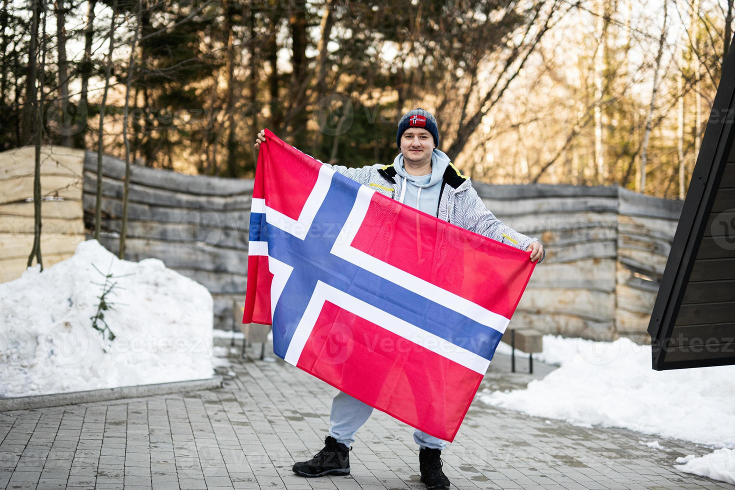 Portrait of man holding Norway flag. Scandinavian culture, norwegian people. photo