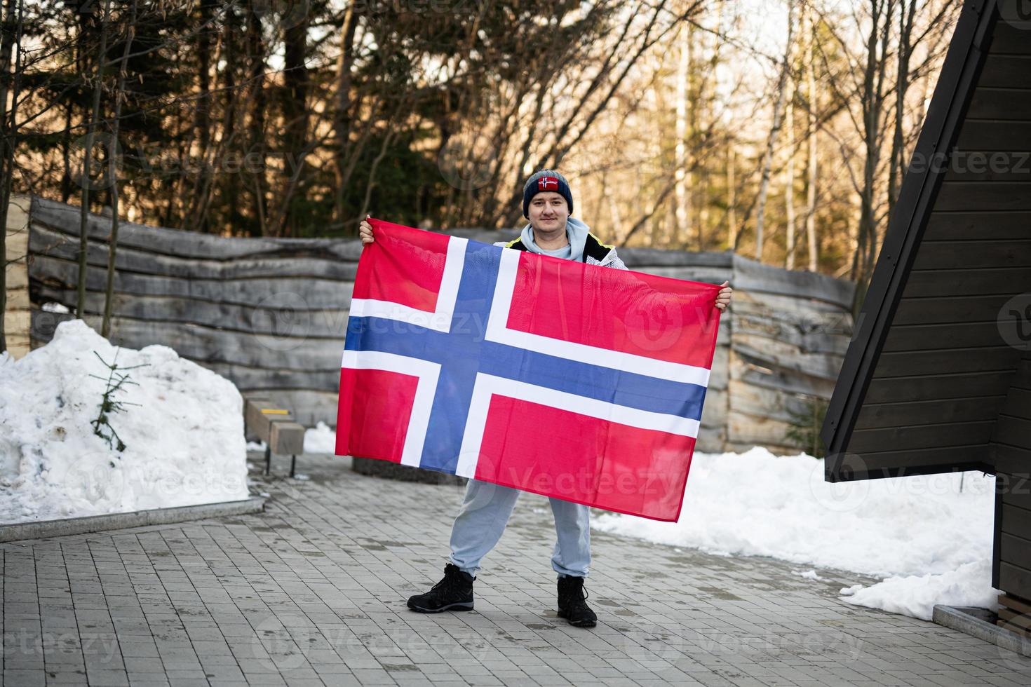 Portrait of man holding Norway flag. Scandinavian culture, norwegian people. photo