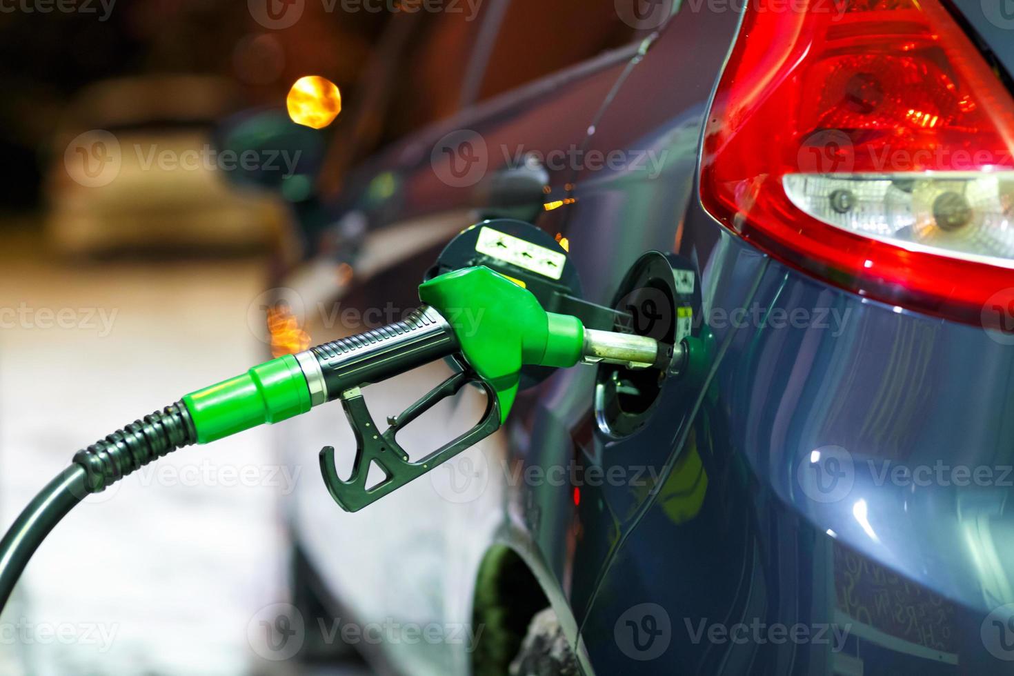 Car refueling on a petrol station in winter at night photo