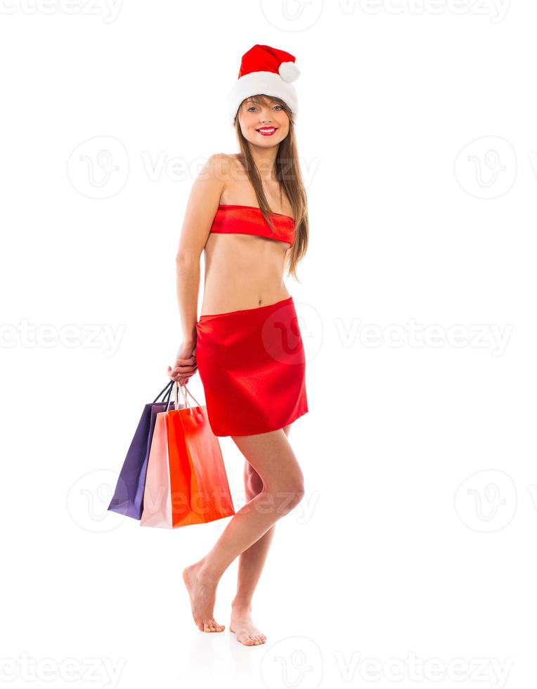 Beautiful Santa christmas girl with shopping bags on white photo